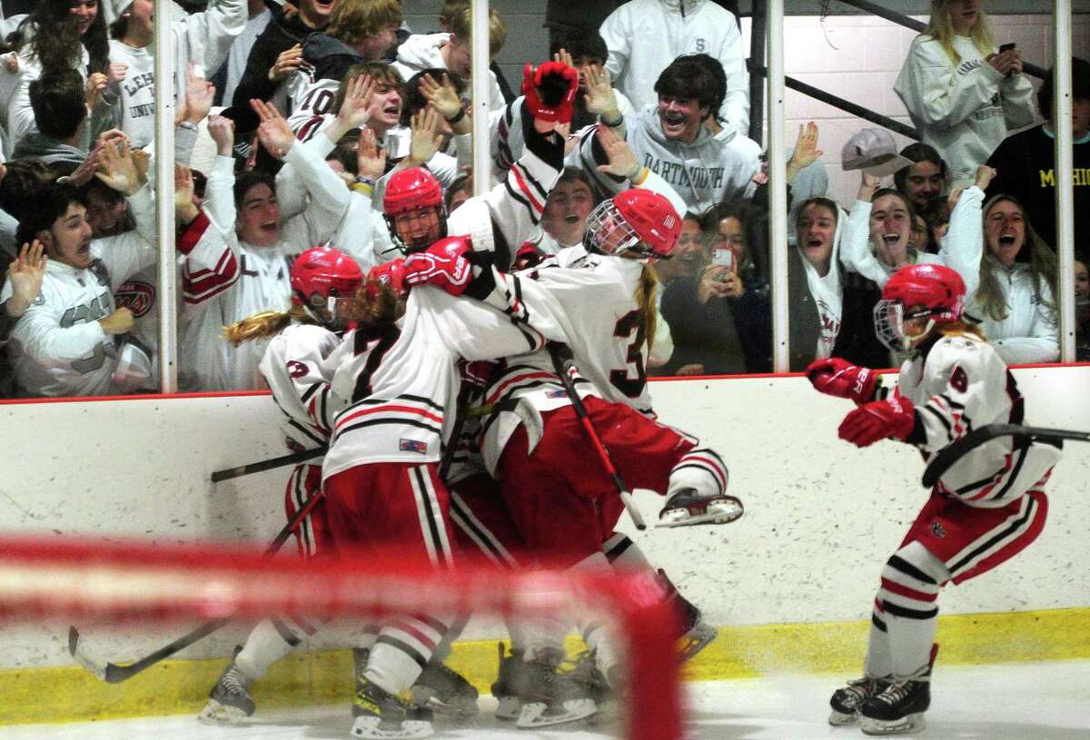 New Canaan celebrates its win over Darien in Connecticut High School Girls Hockey Association state final action at Darien Ice House in Darien, Conn., on Saturday March 9, 2022. New Canaan broke the 3-3 tie in triple overtime.