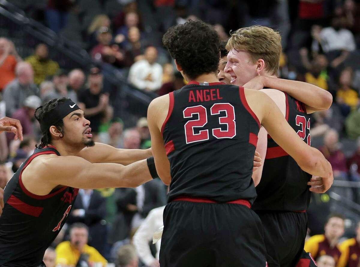 Stanford’s Jaiden Delaire (left), Brandon Angel and others congratulate the Cardinal’s James Keefe (right) after the forward hit a shot as time expired to beat Arizona State 71-70.