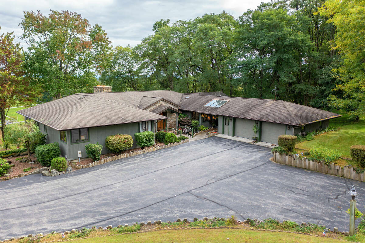 This week’s house was built into a hillside along 1139 Middleline Road in Milton, which created a beautiful view from the deck and single-story living at the same time. Some of the 1990s interiors may need a makeover, but the natural elements used in the design are timeless. Exterior interest includes a bridge over a water feature at the front door. The house has four bedrooms and four bathrooms — one bedroom and bathroom are part of an in-law suite. The house has an open layout, a heated, three-car garage, two fireplaces and sits on a 14-acre-lot. Built in 1991, the house has 4,239 square feet of living space. Ballston Spa schools. Taxes: Approximately $8,000. List price: $975,000. Contact listing agent Karan Murray with Roohan Realty at 518-312-0723.