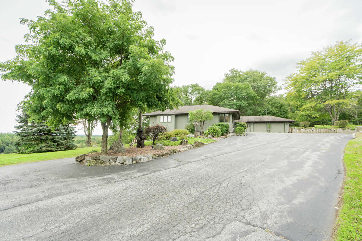 This week’s house was built into a hillside along 1139 Middleline Road in Milton, which created a beautiful view from the deck and single-story living at the same time. Some of the 1990s interiors may need a makeover, but the natural elements used in the design are timeless. Exterior interest includes a bridge over a water feature at the front door. The house has four bedrooms and four bathrooms — one bedroom and bathroom are part of an in-law suite. The house has an open layout, a heated, three-car garage, two fireplaces and sits on a 14-acre-lot. Built in 1991, the house has 4,239 square feet of living space. Ballston Spa schools. Taxes: Approximately $8,000. List price: $975,000. Contact listing agent Karan Murray with Roohan Realty at 518-312-0723.