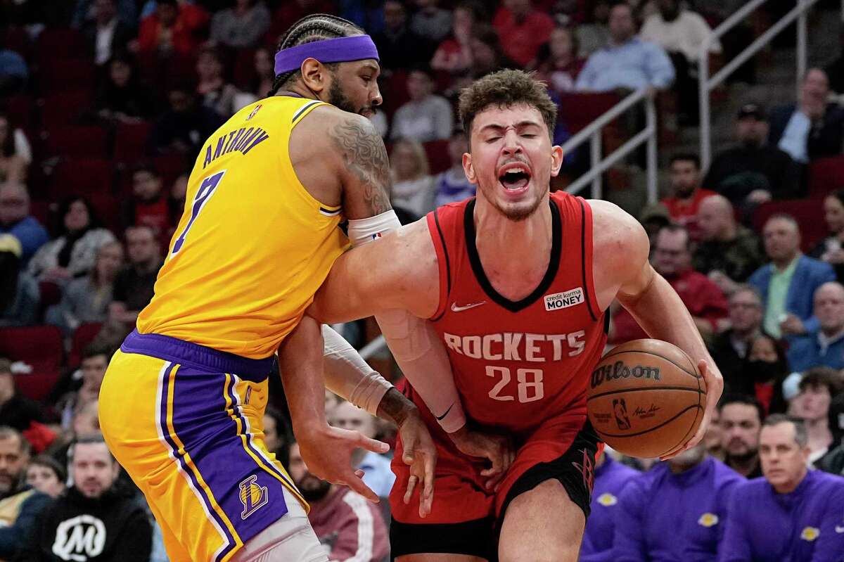 Houston Rockets' Alperen Sengun (28) is fouled by Los Angeles Lakers' Carmelo Anthony (7) during the second half of an NBA basketball game Wednesday, March 9, 2022, in Houston. The Rockets won 139-130 in overtime. (AP Photo/David J. Phillip)