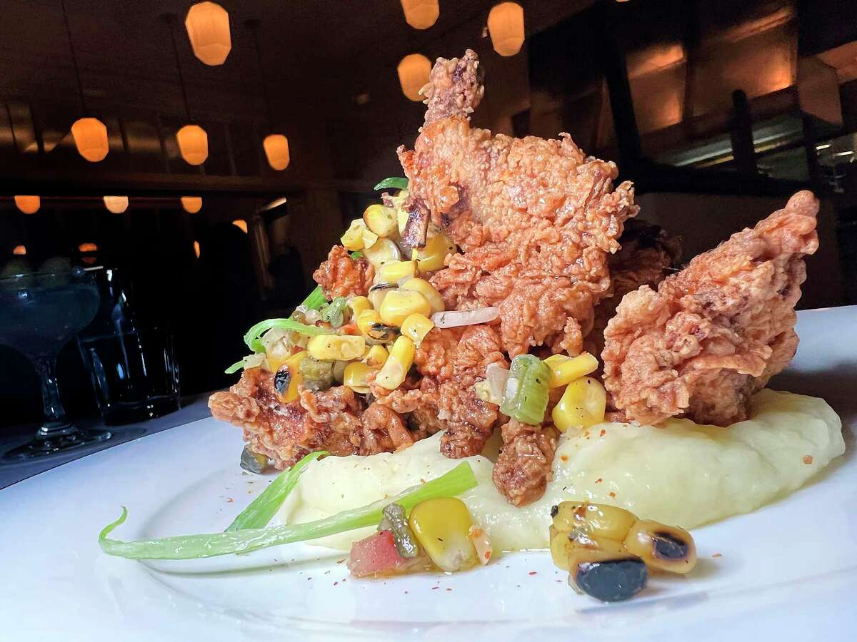 Fried quail is smoked and served with mashed potatoes and pickled corn relish at Supper, the restaurant at Hotel Emma at the Pearl.