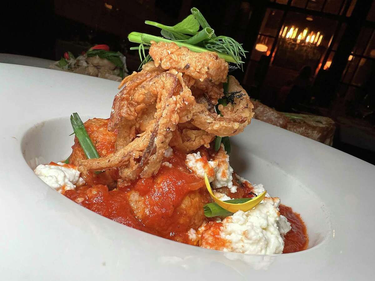 Pork meatballs incorporate peppers, tomato sauce, ricotta cheese and fried shallots at Supper, the restaurant at Hotel Emma at the Pearl.