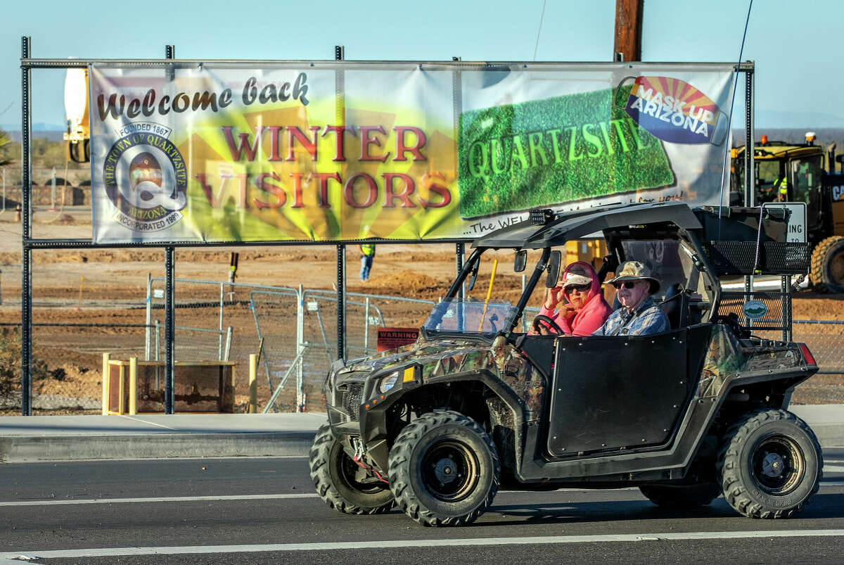 A retired couple drive their UTV (utility task vehicle) along Main Street in Quartzsite, Arizona. Big Rapids is considering whether to allow UTVs (also known as side-by-sides) on city streets.