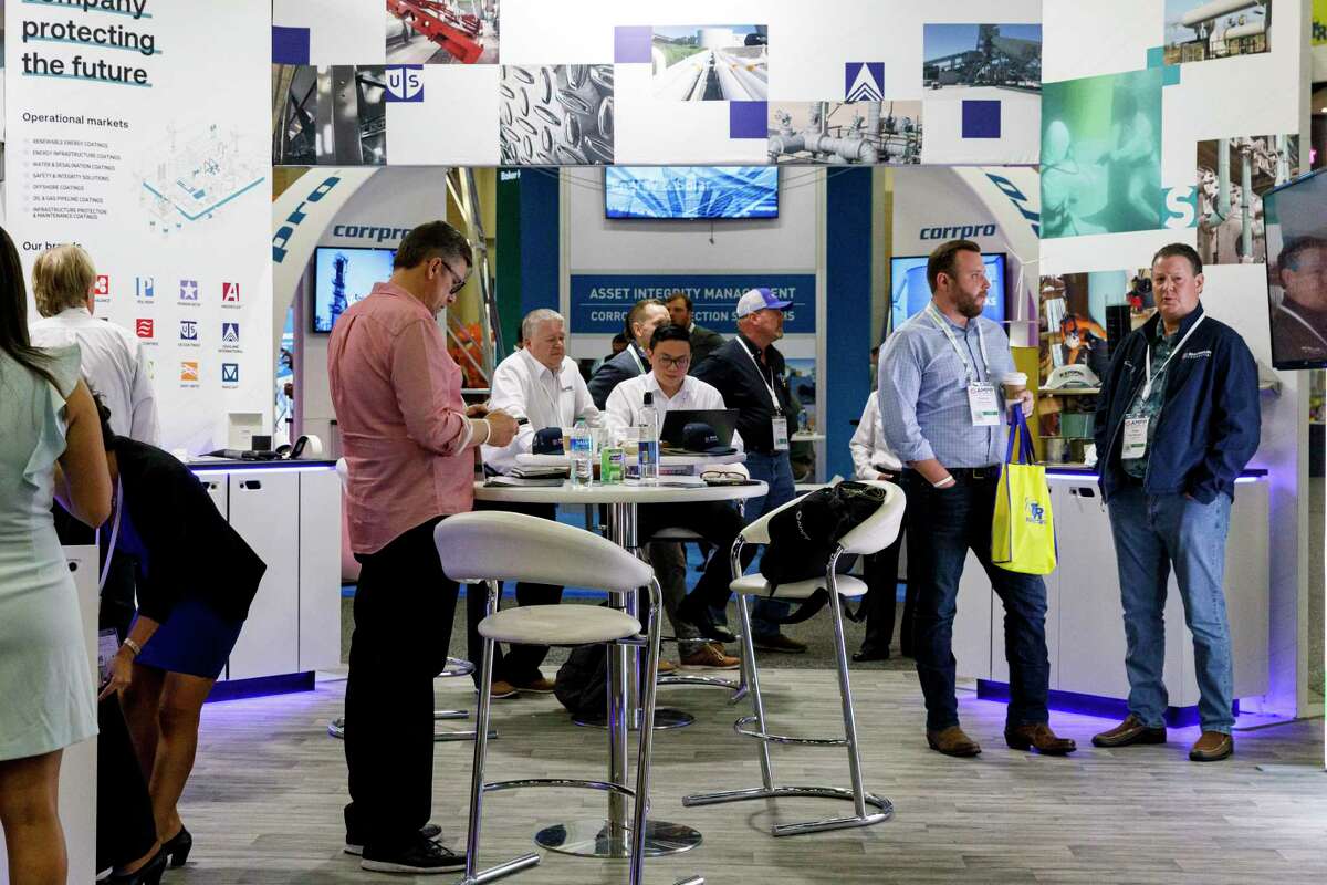 People mingle around the exhibit booths during the Association for Materials Protection and Performance’s conference at the Henry B. González Convention Center.