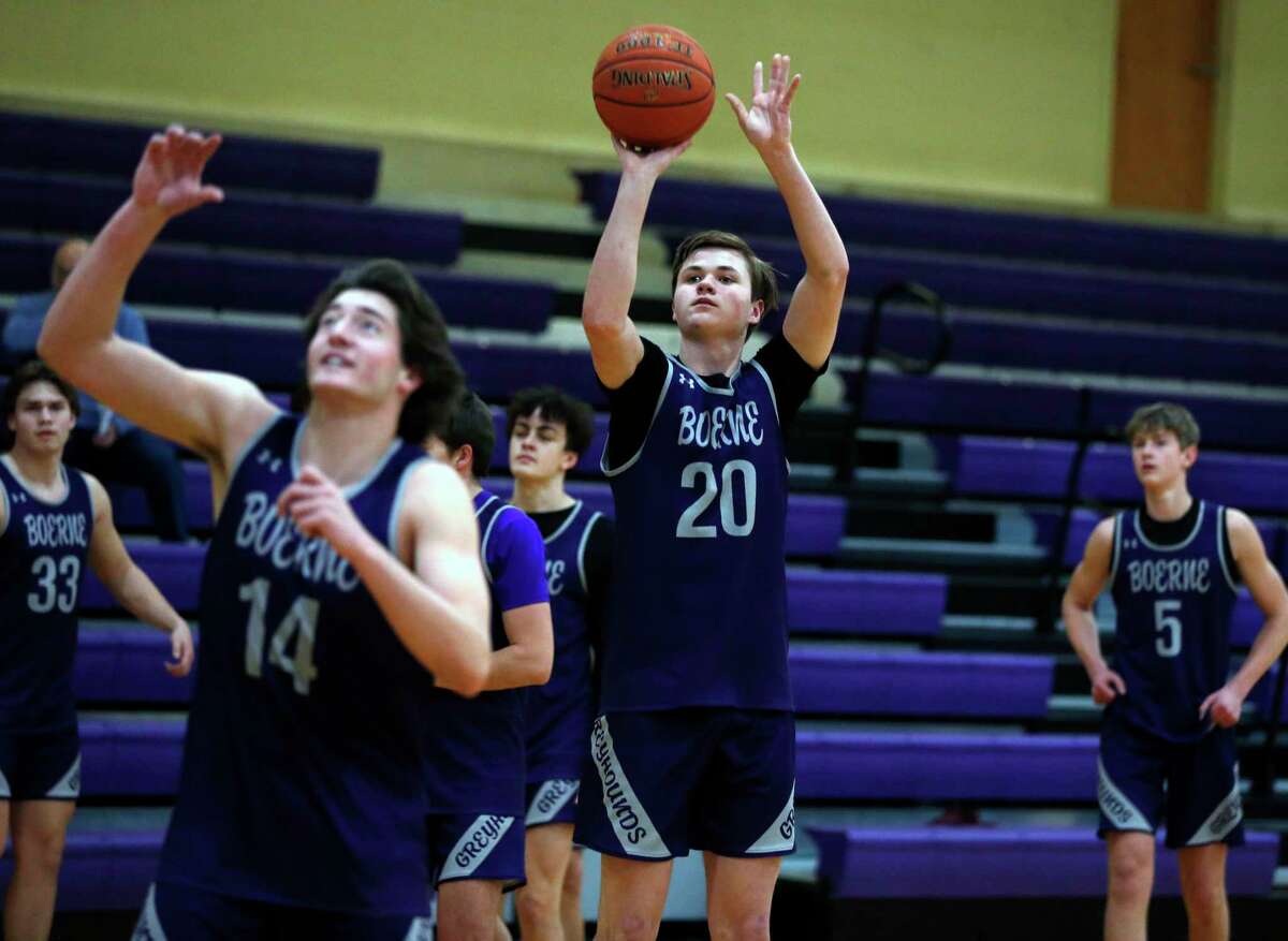 Boerne forward Devin Styles (20 goes thru shooting drills with the rest of the team in preparation for their UIL boys playoff game on Tuesday, March 8, 2022.