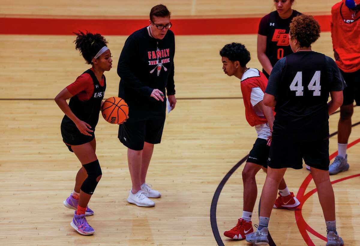 Zhane Duckett, 21, a sophomore point guard for Cal State East Bay's women's basketball team, runs a play with head coach Shanele Stires during practice at Pioneer Gym on Wednesday, March 9, 2022, in Hayward, Calif. Duckett, who's from Oakland and starred at St. Joseph Notre Dame High School in Alameda, lost her mother, Kimberly Duckett, to breast cancer at the start of the season. Playing to honor her mother's memory, Duckett - an all-conference selection - has guided the Pioneers to their best record in program history.