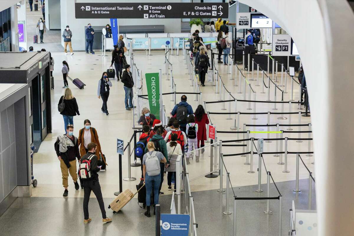 Passengers go through TSA security checkpoint before catching their flights at San Francisco International Airport.