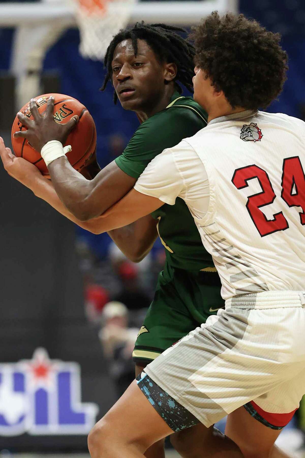 Cole Cougars' Dre Ray is defended by Hitchcock Bulldogs' Lloyd Jones III during the second half of the Class 3A State Semifinals at the Alamodome, Thursday, March 10, 2022. Cole won, 53-49 and moves on to the final game against Dallas Madison on Saturday.
