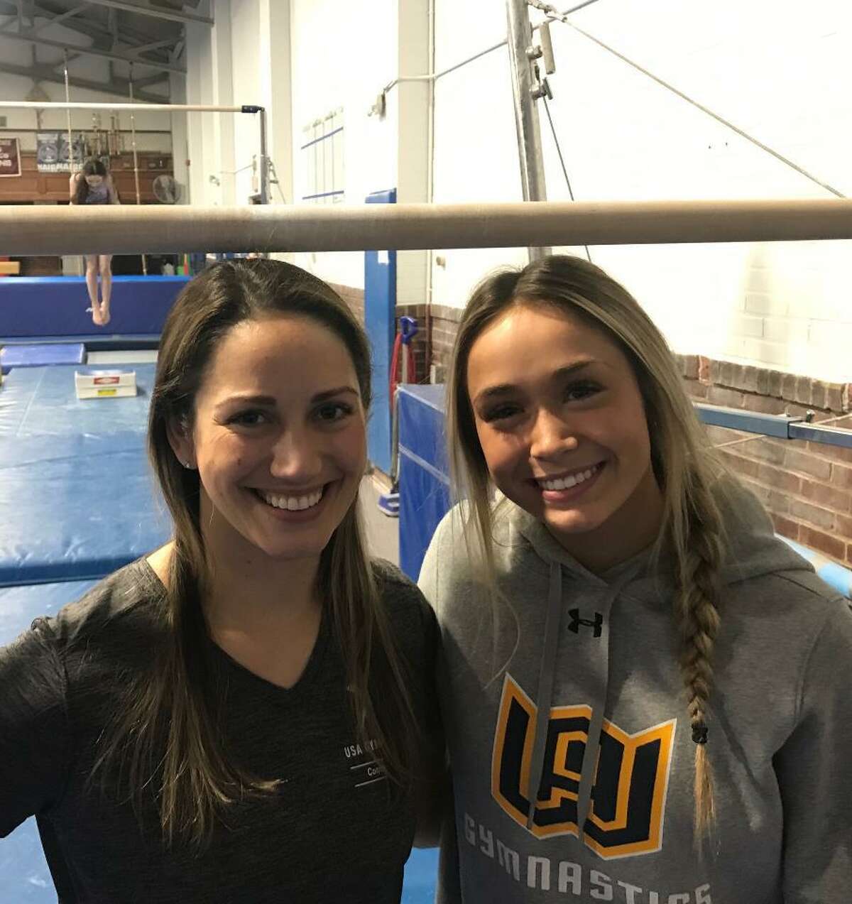 Woodstock Academy gymnastics coach Kasey Tocchio, left, and Taylor Markley, who won each individual event, helped Woodstock Academy to its eighth State Open title in the past 10 years.
