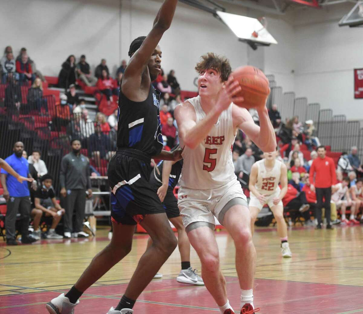 Fairfield Prep's Griffin Harding drives to the basket against West Haven defender Javaun Calhoun during their second round game in the CIAC 2022 State Boys Basketball Tournament at Fairfield Warde High School in Fairfield, Conn., on Thursday, March 10, 2022.