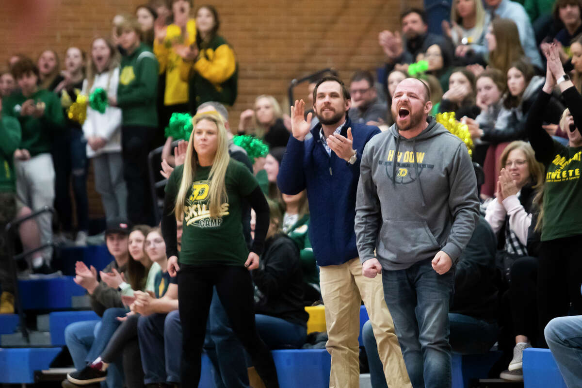 Dow fans cheer after a basket during the Chargers' regional final victory over Grand Blanc Thursday, March 10, 2022 at Midland High School.