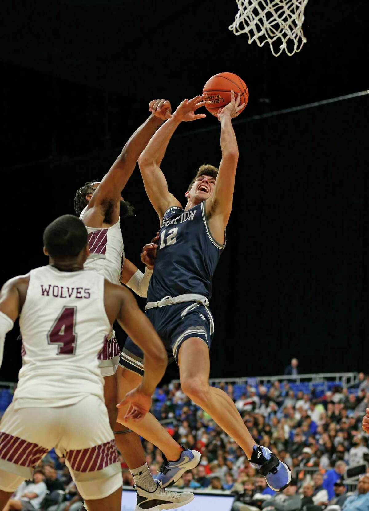 Boerne Champion guard Braxton Burdick (12) shoots over Mansfield Timberview defenders. Boerne Champion defeated by Mansfield Timberview 55-43 in Class 5A state semifinal l on Thursday, March 10, 2022 at the Alamodome.