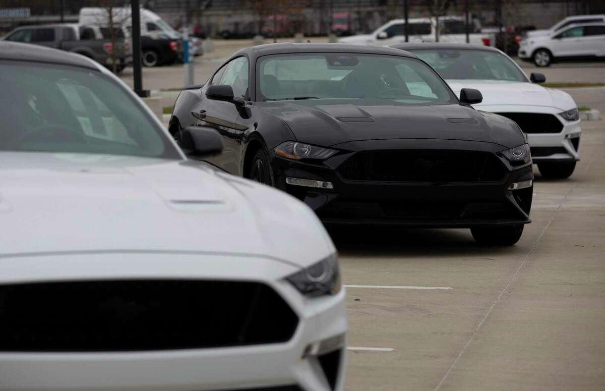 New Mustangs are lined up at the dealership lot Thursday, Jan. 20, 2022, at Doggett Ford in Houston. The vehicles are spaced out because the inventory is low. Salesmen said the parking lot could hold over 400 vehicles, but they currently have under 30 vehicles available at the lot. The Conroe City Council agreed to put their name on a waiting list as the nationwide vehicle shortage continues to make it almost impossible to purchase new vehicles.