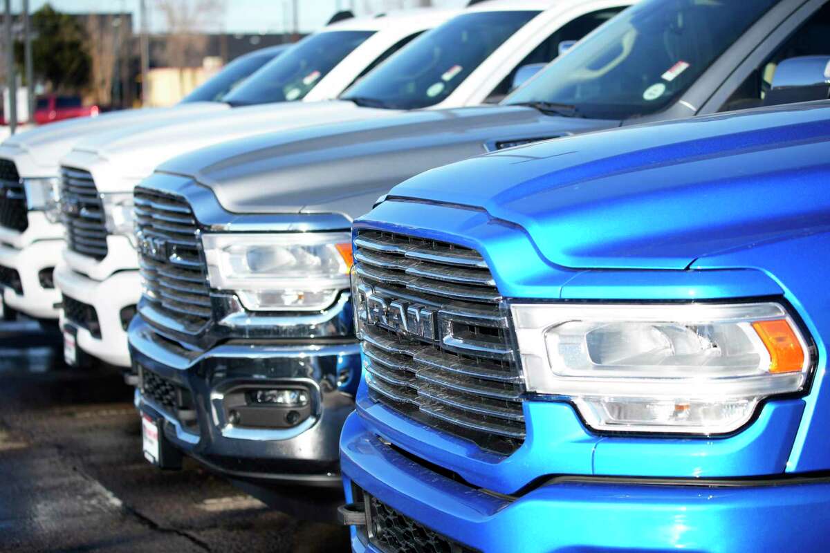 Unsold 2022 Ram pickup trucks sit in short row outside a Dodge dealership Sunday, Feb. 27, 2022, in Littleton, Colo. The Conroe City Council agreed to put their name on a waiting list as the nationwide vehicle shortage continues to make it almost impossible to purchase new vehicles.