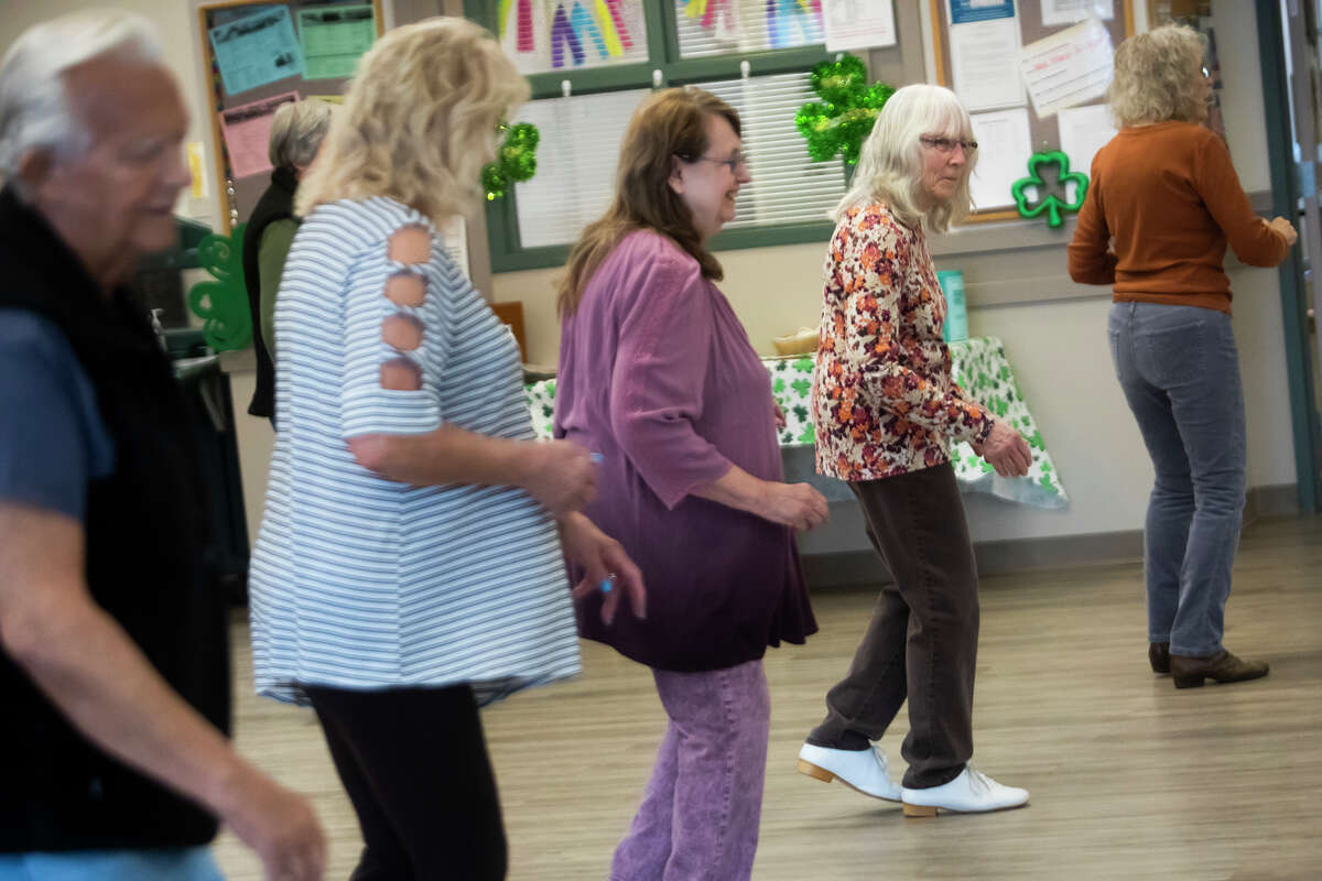About a dozen people participate in a line dancing class Friday, March 11, 2022 at Trailside Activity and Dining Center in Midland.