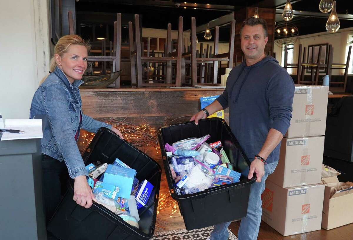 Restaurant owner Nick Martschenko and bartender Urzula Voynick are collecting a range of items to help victims of the Russian invasion. They showed off some of the donations in South End restaurant in New Canaan on March 10, 2022.
