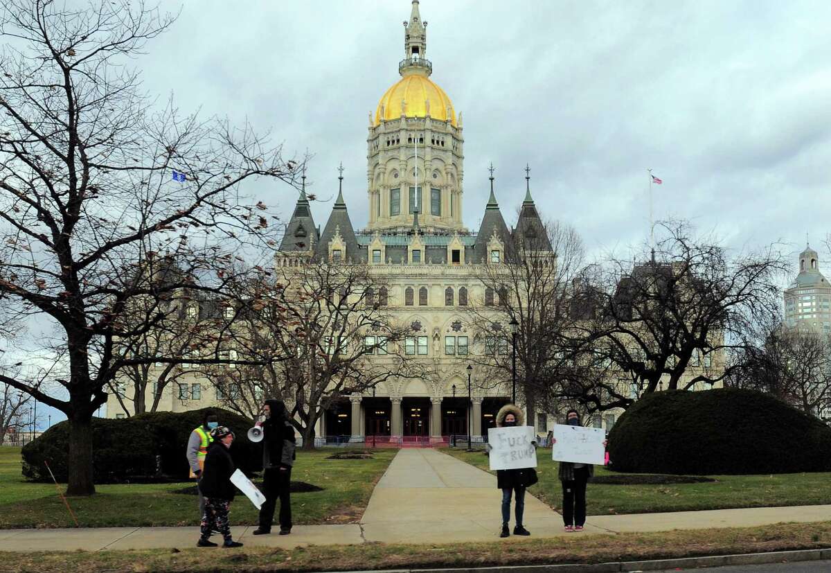 Protesters stand outside of the capitol building in Hartford in 2020.