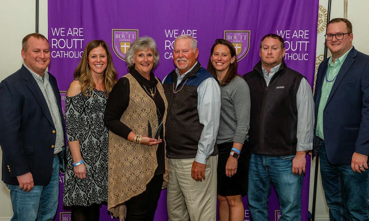 Jerry and Cindy Johnson (center) are honored as Alumni of the Year during Routt Catholic High School's Winter Celebration. The award was presented by Brad Johnson, Emily Howse, Kelly Siedentop, Kevin Johnson and Adam Johnson.