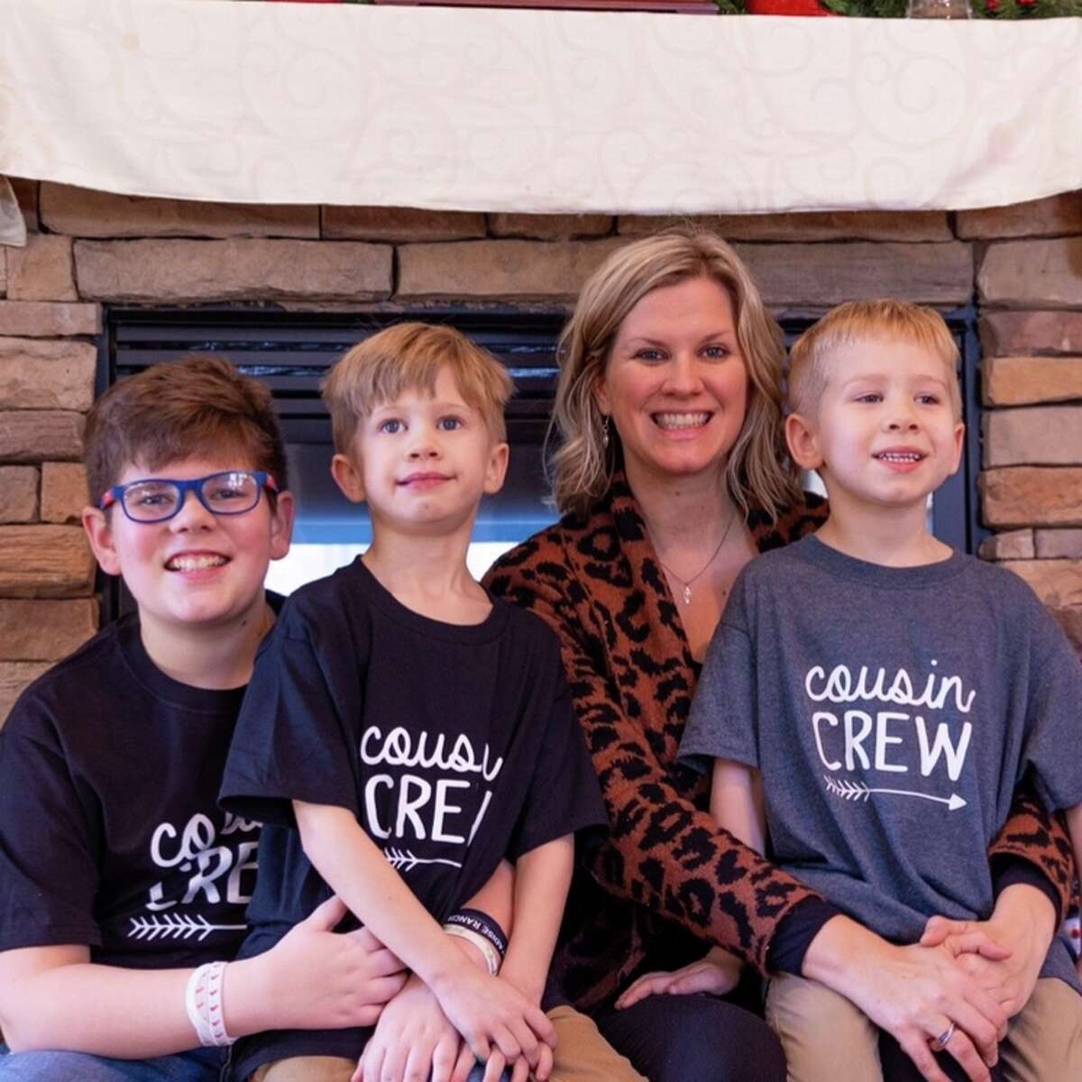 Kendra Prudhomme-Smith sits for a family photo with her three sons. 