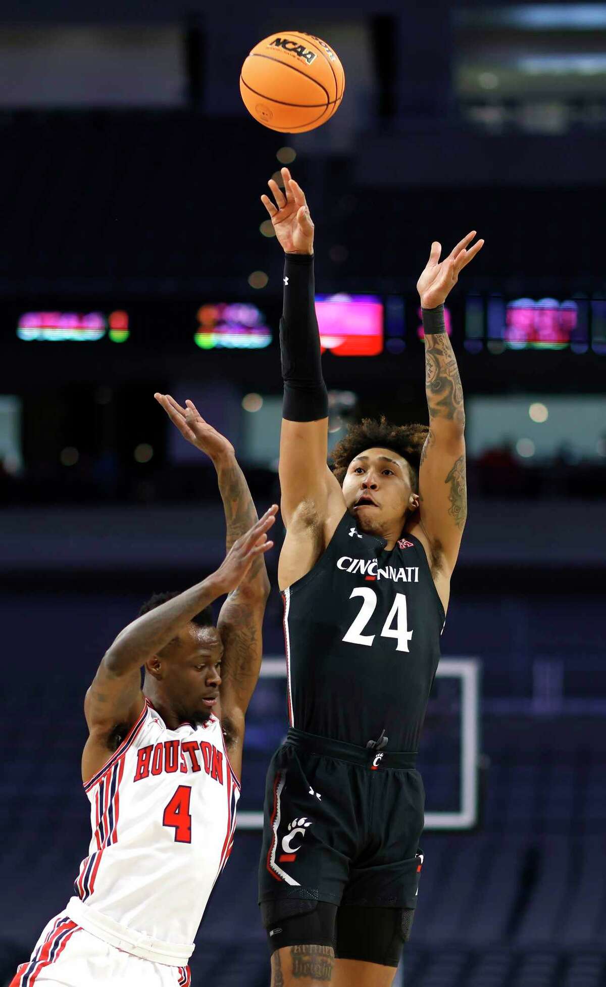 FORT WORTH, TX - MARCH 11: Jeremiah Davenport #24 of the Cincinnati Bearcats shoots the ball over Taze Moore #4 of the Houston Cougars in the first half of the American Athletic Conference Mens Basketball Tournament Quarterfinals at Dickies Arena on March 11, 2022 in Fort Worth, Texas.