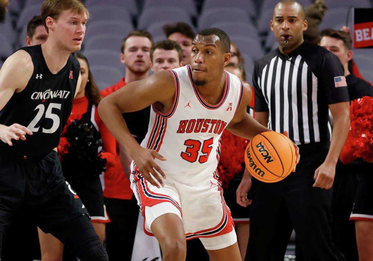 FORT WORTH, TX - MARCH 11: Fabian White Jr. #35 of the Houston Cougars dribbles as Hayden Koval #25 of the Cincinnati Bearcats defends in the first half of the American Athletic Conference Mens Basketball Tournament Quarterfinals at Dickies Arena on March 11, 2022 in Fort Worth, Texas.