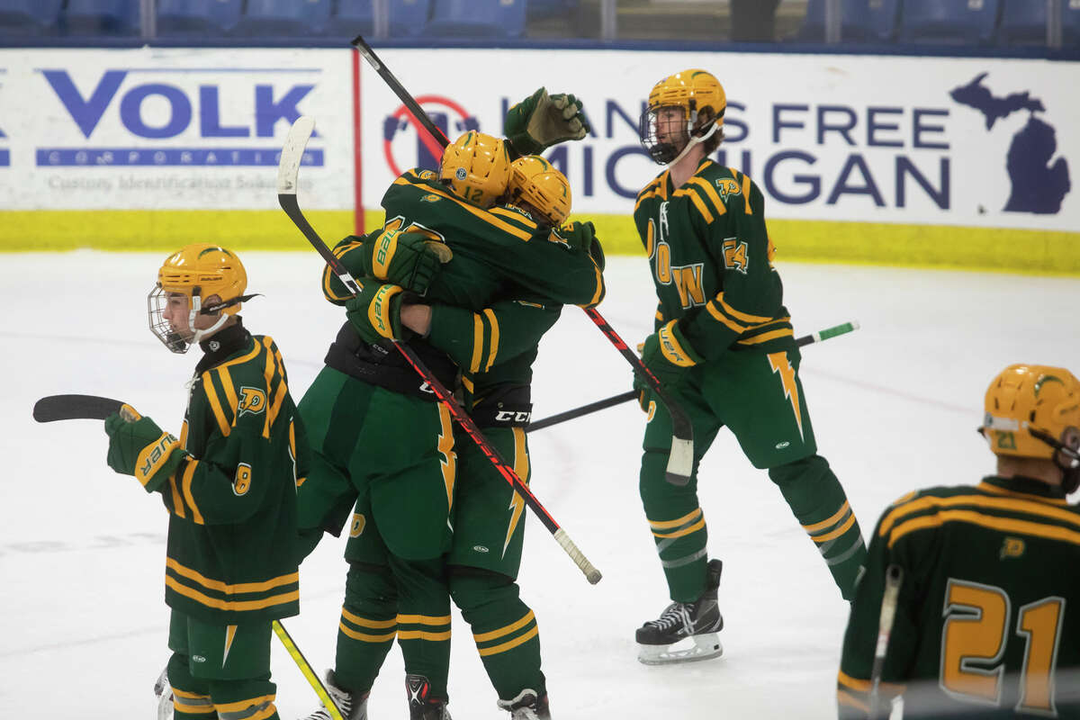 Dow players celebrate after their state semifinal victory over Calumet Friday, March 11, 2022 at USA Hockey Arena in Plymouth.