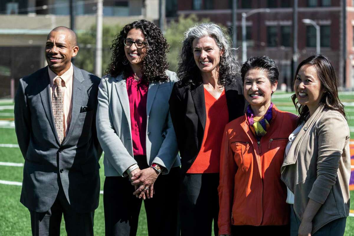 San Francisco Board of Education members Kevine Boggess (left), Lisa Weissman-Ward, Lainie Motamedi, Ann Hsu and Board President Jenny Lam stand for a photo after a swearing-in ceremony for Hsu, Weissman-Ward, and Motamedi at San Francisco’s Galileo High School on Friday.