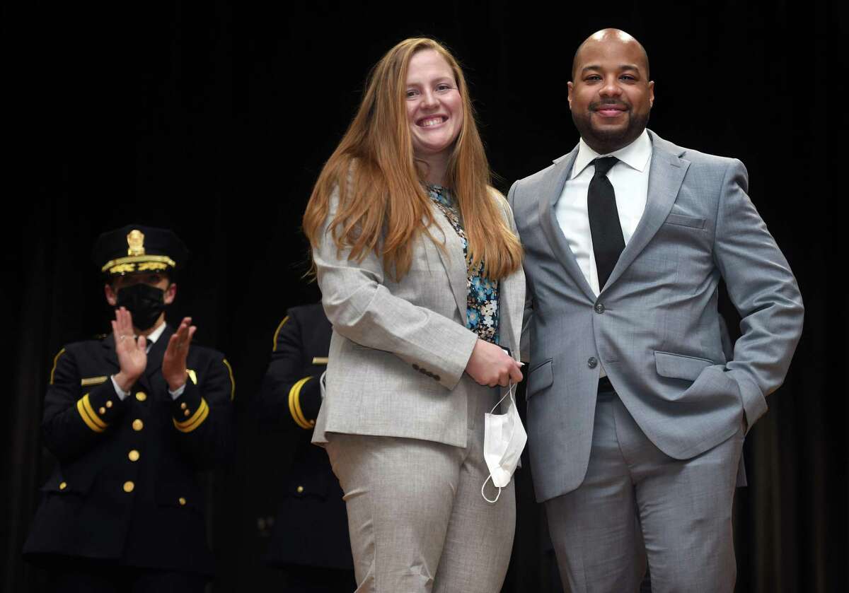 Fiancees and Detectives Maegan Moran and John Moore pose for photographs during a Detectives Promotional Ceremony for the New Haven Police Department at Wilbur Cross High School in New Haven on March 11, 2022. The couple were part of a group of ten promoted to the rank of detective.