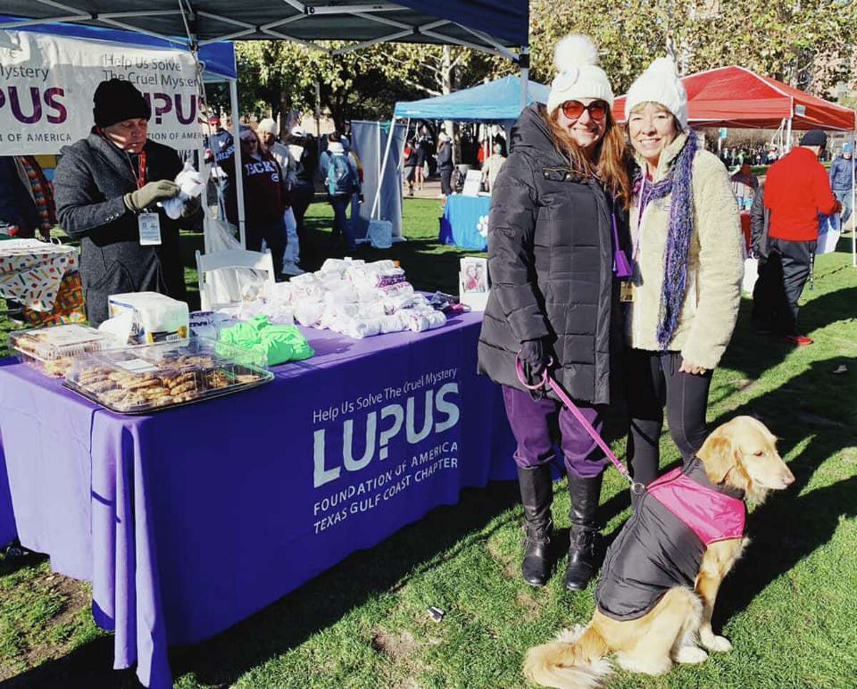 Cheryl Yetz, left, and her longtime friend Donna Vazquez pose at the Lupus Foundation of America Texas Gulf Coast Chapter booth at a marathon.