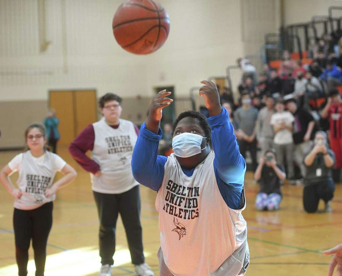 Rahim Ndikumana shoots a basket during the Shelton Unified Athletics' basketball game during halftime of the annual student/faculty game at Shelton Intermediate School in Shelton, Conn., on Tuesday, March 8, 2022.
