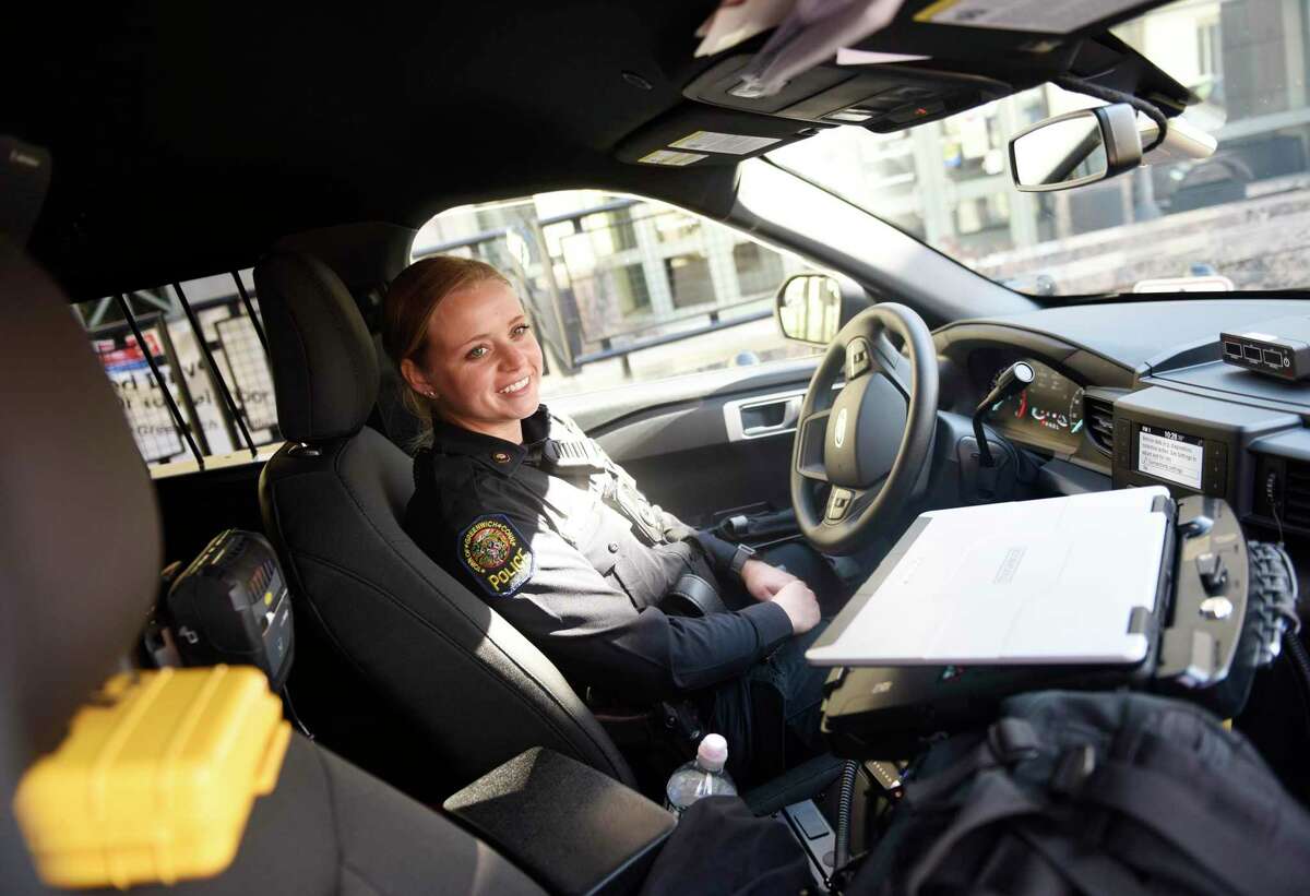 Patrol Officer Kassidy Schupp chats in the driver's seat of a new hybrid police cruiser outside the Public Safety Complex in Greenwich, Conn. Tuesday, March 3, 2022. The Greenwich Police Department recently added four hybrid Ford Explorers to its fleet, marking the first hybrid vehicles to be used by GPD.