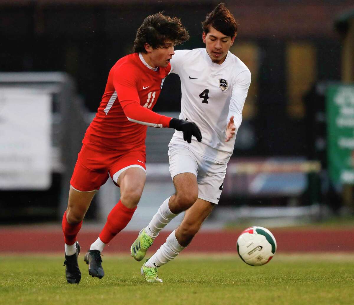 The Woodlands' Cody Tice (11) dribbles the ball against Conroe's Bernardo Fernandez (4) in the first period of a high school soccer match at The Woodlands High School, Friday, March 11, 2022, in The Woodlands.