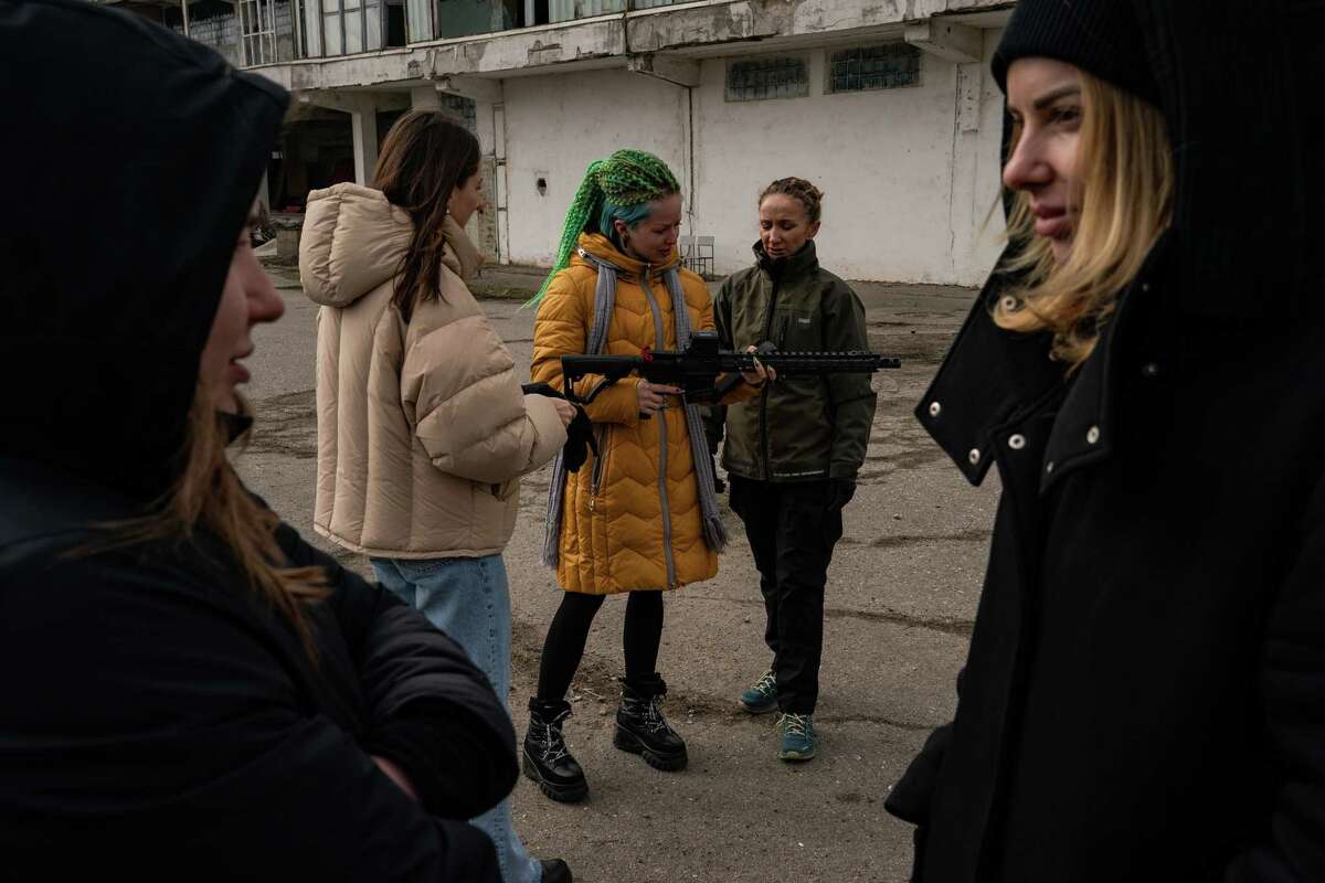 A woman who gave her name as Katya examines a rifle during a weapons training session this week in Odessa, Ukraine. She said she worked as a dance coach and city guide and had dreamed of one day emigrating. "But not now. Now I feel that my place is here, in my motherland."