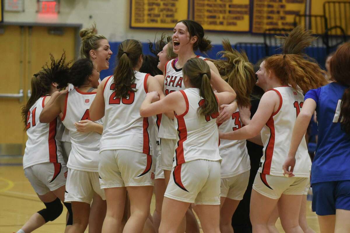 Members of the Sacred Heart Academy girls basketball team celebrate during their Class MM semifinal win over St. Paul on Friday.