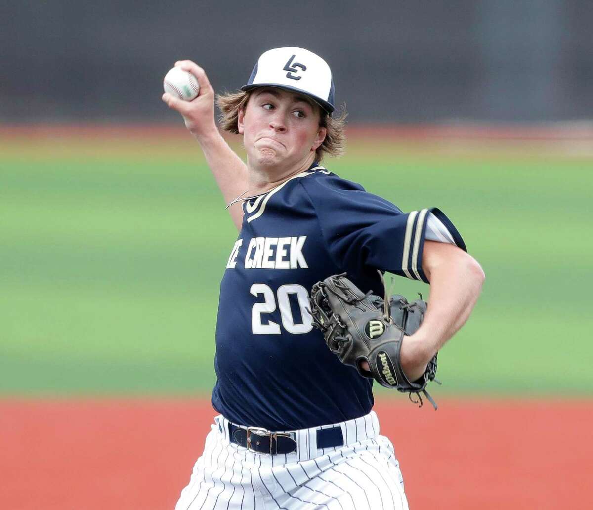 Lake Creek starting pitcher Jack Haag (20) throws in the first inning of a high school baseball game at Grand Oaks High School, Friday, March 11, 2022, in Spring.