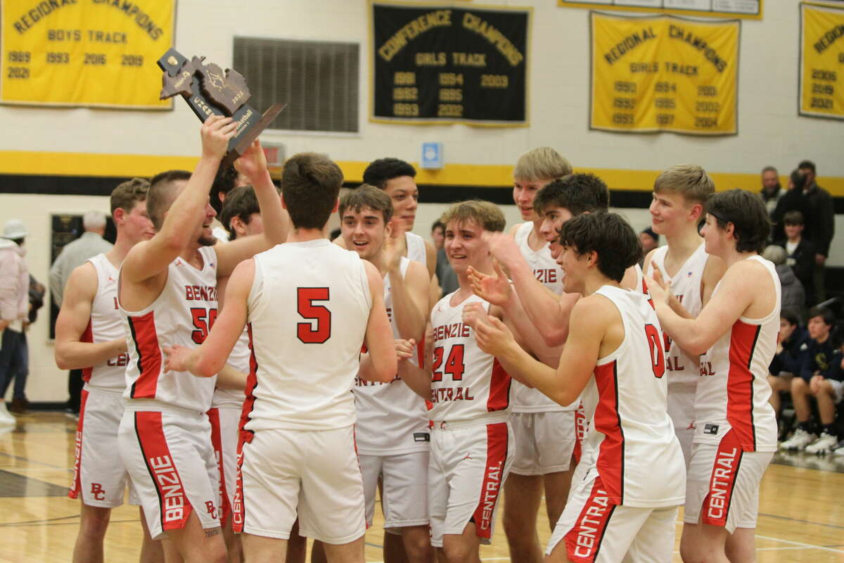 Benzie Central basketball celebrates winning the district title.