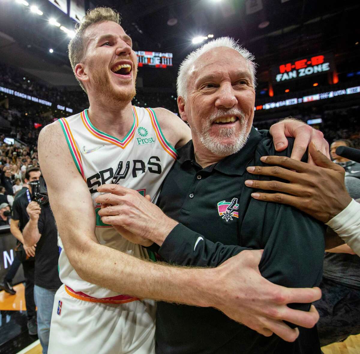 San Antonio Spurs head coach Gregg Popovich celebrates Friday, Mar 11, 2022 at the AT&T Center in San Antonio with San Antonio Spurs center Jakob Poeltl (25) after the Spurs beat the Utah Jazz 104-102. The win gives Popovich 1.336 wins and gives him the most regular season wins in NBA history.