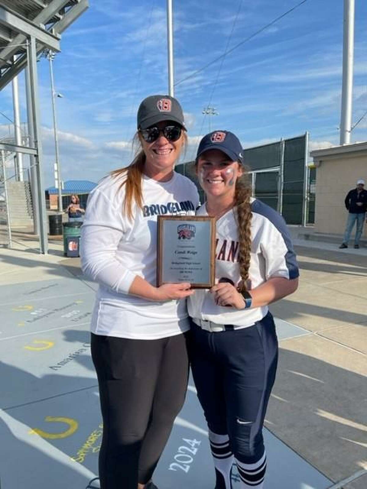 Bridgeland head coach Candi Weige earned her 200th career win after the Lady Bears went 2-0 on day one of the Cy-Fair Varsity Tournament on Thursday, March 3. Pitcher Makenzi Jenkins, holding the plaque, helped with 78 of those wins.