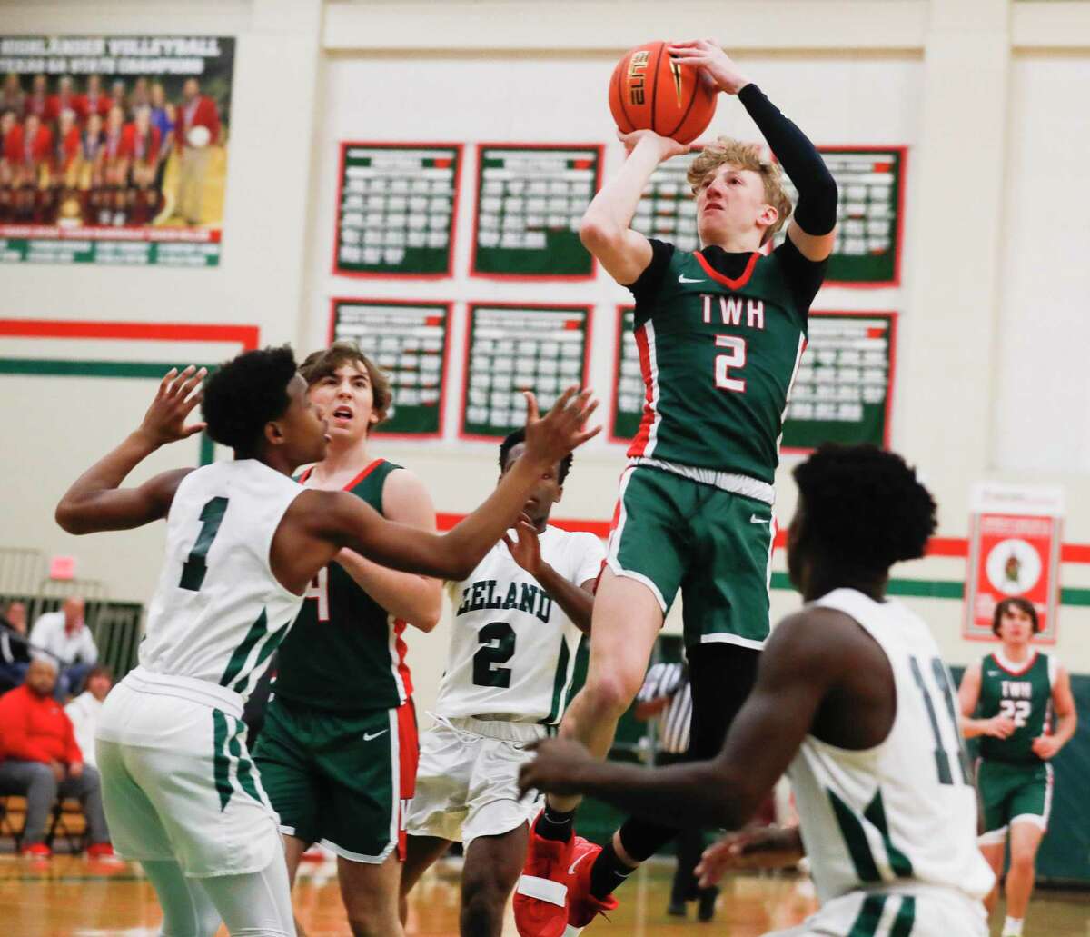 The Woodlands’ Shey Eberwein (2) shoots between defenders during a game at the Rebounders Club Classic at The Woodlands High School, Friday, Nov. 26, 2021, in The Woodlands.
