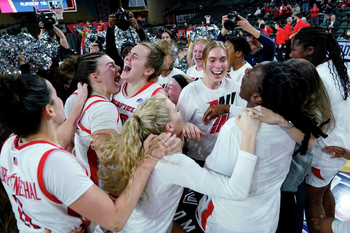 Fairfield players celebrate after defeating Manhattan 73-68 in the MAAC championship on March 12.