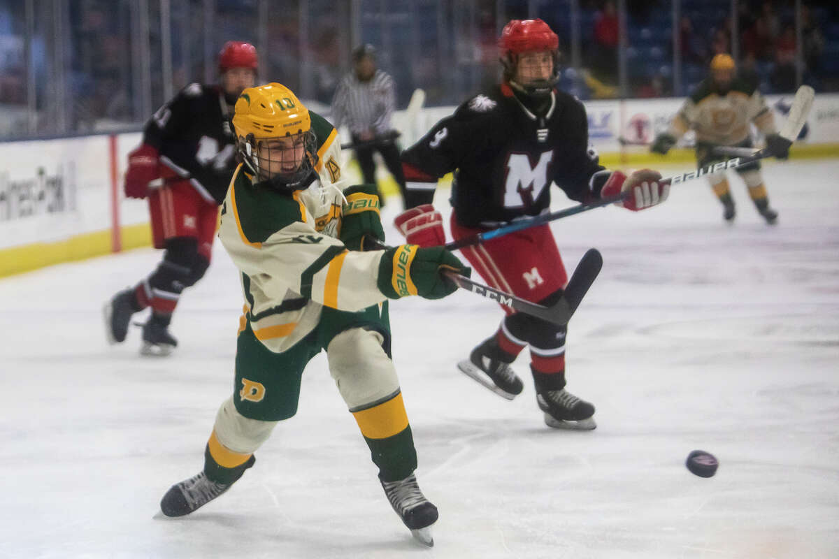 Dow's Caden Chritz takes a shot on goal during the Chargers' state finals victory over St. Mary's Saturday, March 12, 2022 at USA Hockey Arena in Plymouth.