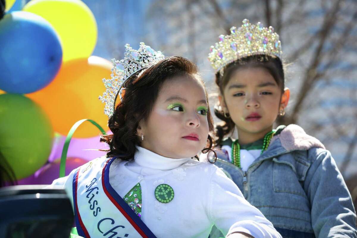 Evelyn Pioquinto, left, waits for the start of the 61st Annual St. Patrick’s Day Parade Saturday, March 12, 2022, in downtown Houston. Pioquinto is Miss Chiquitita Baby Houston.