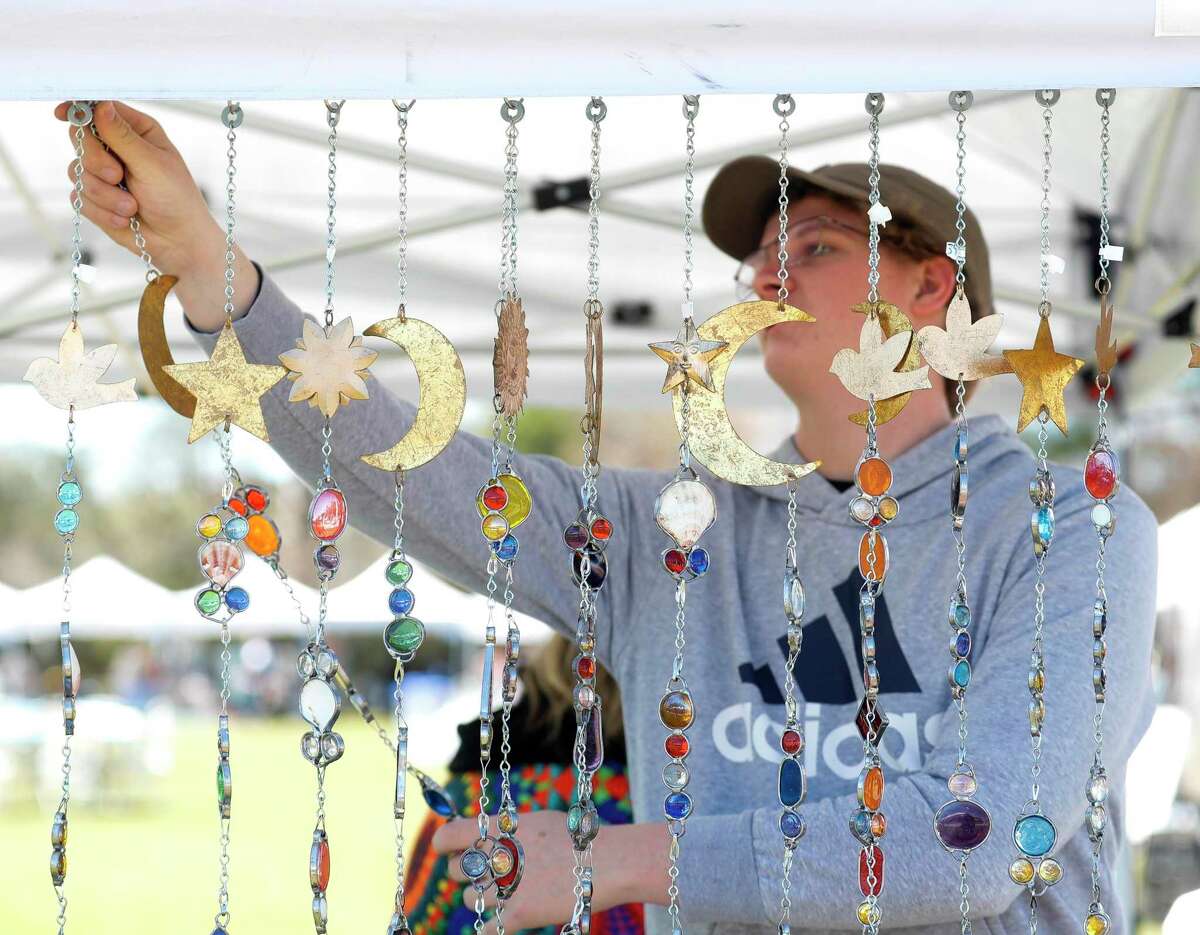 Shawn Couet hangs art pieces during Arts in the Park at Northshore Park, Saturday, March 12, 2022, in The Woodlands. The annual free event featured local vendors with original artwork, live ,music and children’s activities.
