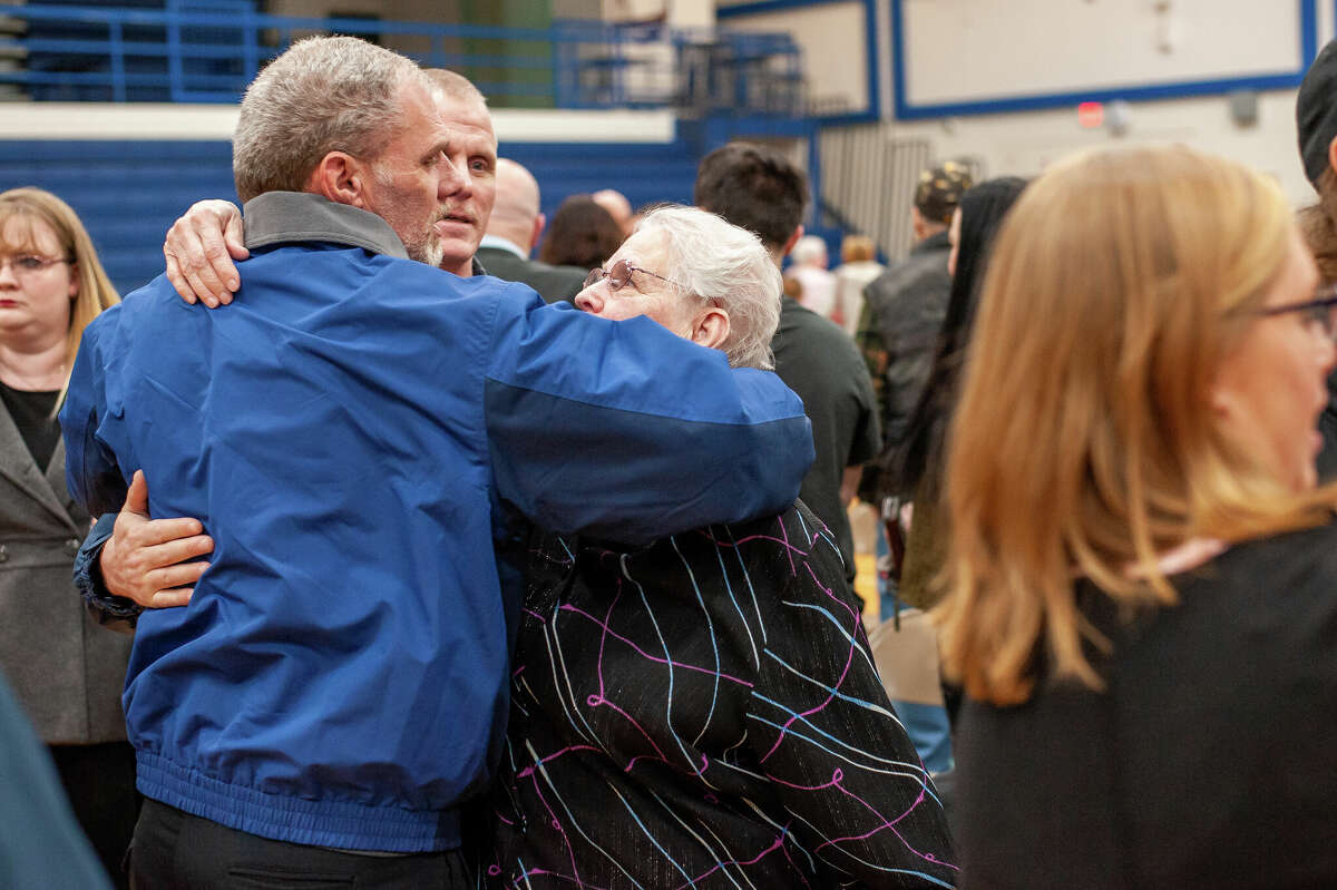 Jan Thorington (middle) recieves a hug at her son's memorial service on March 12, 2022. Johnny Thorington was a beloved bus driver for the Meridian Public Schools district who died from COVID-19 complications last year.