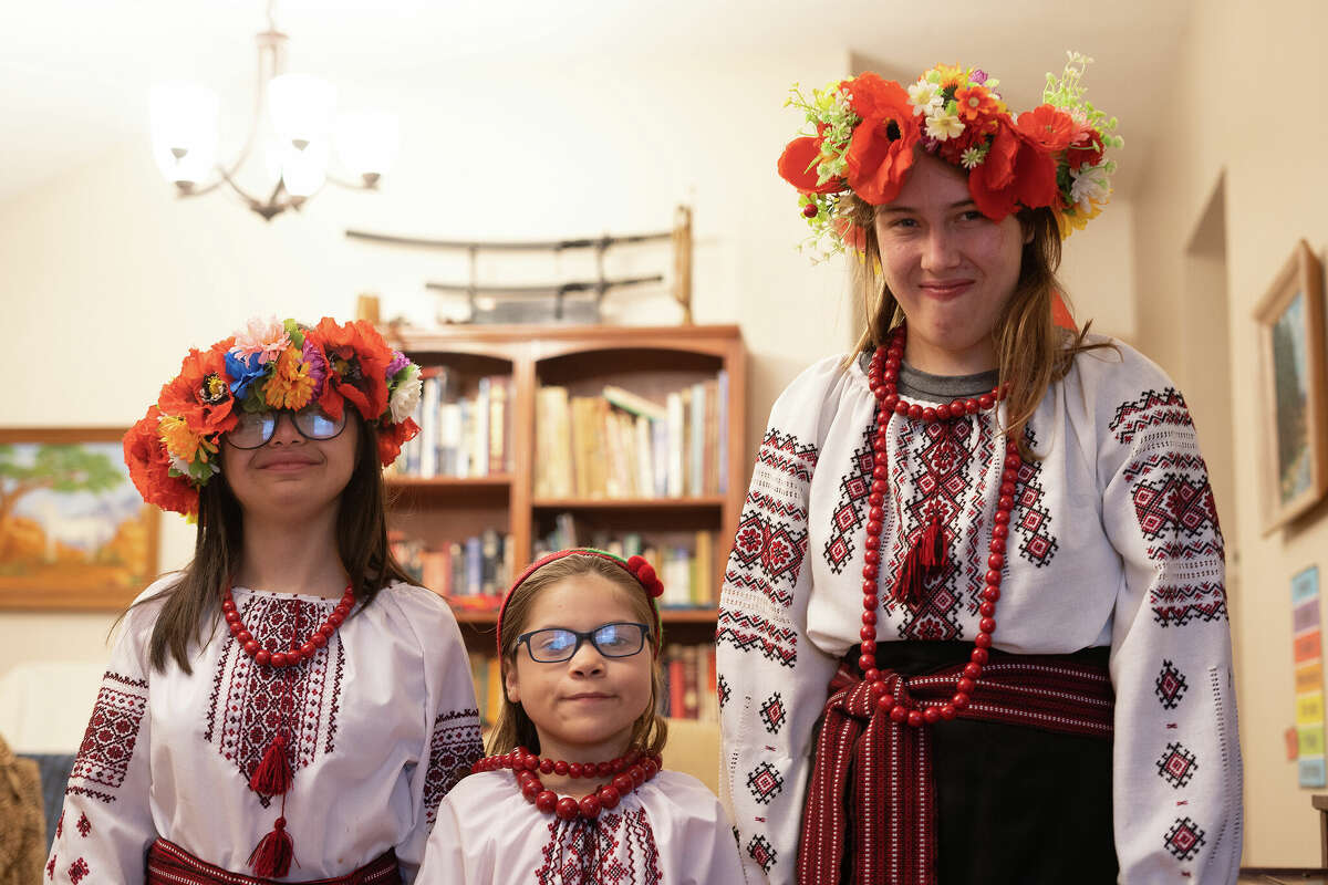 From left: Ivanna, Dayana,and Olesya Thorp. The girls wear their Ukrainian traditional clothing called Vyshyvanka detailed with their headpieces and beads.