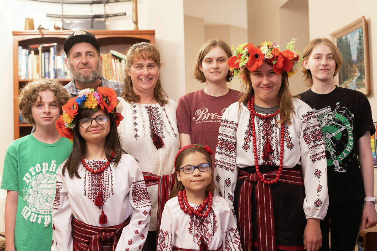 The Thorp family embrace their adopted daughters' Ukrainian roots by dressing in traditional Ukraine clothing called Vyshyvanka on March 11.