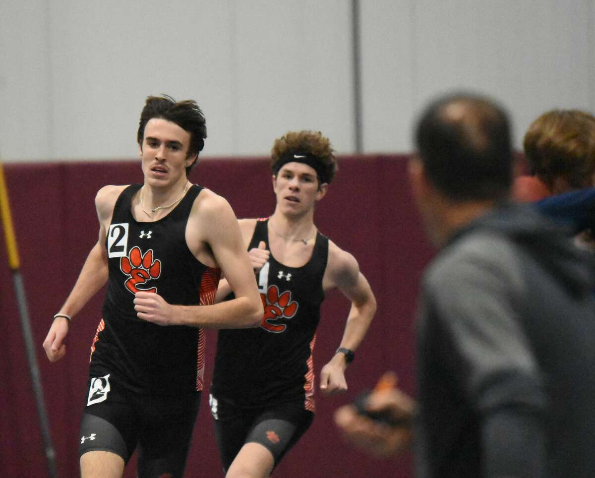 Ryan Watts, left, and Geordan Patrylak run to a 1-2 finish in the 1,600-meter run at the Tiger Indoor Meet on Friday at Principia College in Elsah.