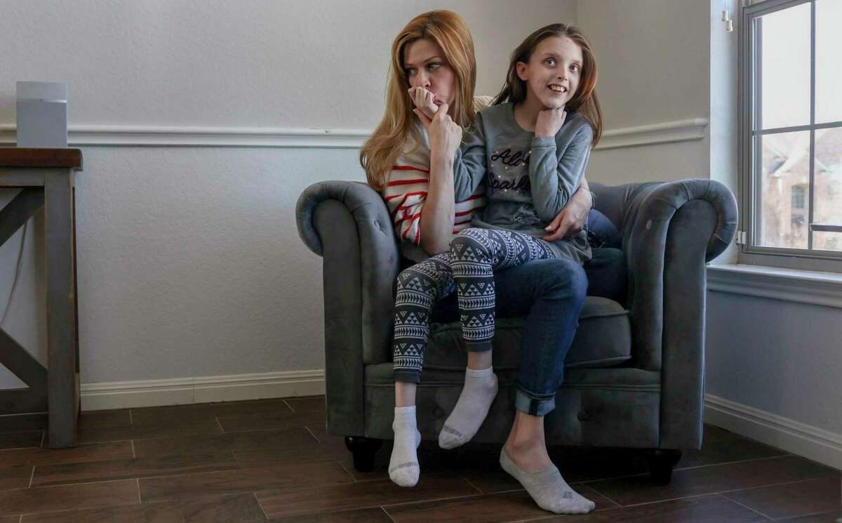 Tiffany Teixidor and her 14-year-old daughter Reily Starnes, 14, are pictured at home in San Antonio on Saturday. Teixidor makes TikTok videos, sharing the joy and challenges of raising Reily, who has a chromosomal microdeletion, while living their best Texas life.