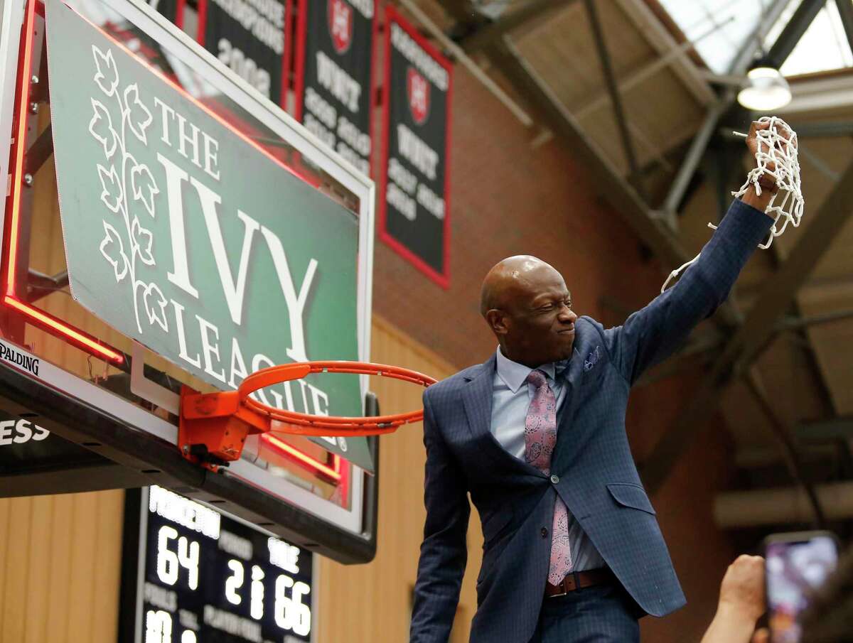 Yale coach James Jones celebrates after cutting down the net after defeating Princeton in the League championship game on Sunday.
